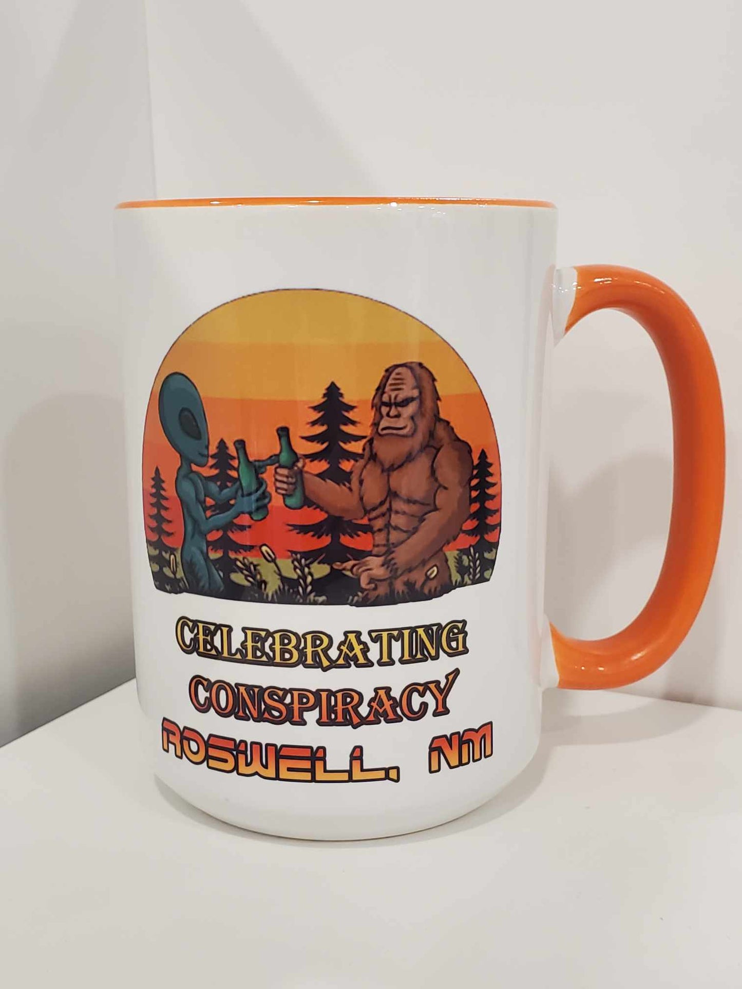 Celebrating Conspiracy Bigfoot Alien Cheers 15oz Coffee Mug Orange